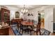 Dining room with hardwood floors, blue rug, and view into the kitchen at 4521 Chicopee Trl, Durham, NC 27707