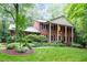 Inviting two-story brick house with a columned porch and lush landscaping, set on a beautifully landscaped lot at 4521 Chicopee Trl, Durham, NC 27707