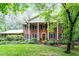 Traditional brick home with a columned porch and well-manicured lawn, exuding Southern charm and elegance at 4521 Chicopee Trl, Durham, NC 27707