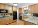 Kitchen featuring granite counters and black appliances, with hardwood floors at 4521 Chicopee Trl, Durham, NC 27707