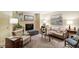 Elegant living room featuring a fireplace, comfortable seating, and soft lighting, perfect for relaxation and gatherings at 4521 Chicopee Trl, Durham, NC 27707