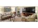 Bright and inviting living room with a large TV, comfortable seating, and a view into adjoining rooms at 4521 Chicopee Trl, Durham, NC 27707