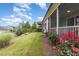 Exterior shot of well-manicured backyard and screened in porch, perfect for enjoying the outdoors at 47 Coventry Ln, Chapel Hill, NC 27516