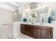 Bright bathroom features a double vanity, large mirror, and walk-in shower at 47 Coventry Ln, Chapel Hill, NC 27516