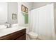 This bathroom features a vanity with a white sink, toilet, and shower with white curtain at 47 Coventry Ln, Chapel Hill, NC 27516