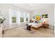 Bright bedroom with large windows, neutral tones, and stylish decor providing a serene and inviting space at 47 Coventry Ln, Chapel Hill, NC 27516