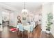Bright dining area with hardwood floors, stylish lighting, and an adjacent kitchen with a center island at 47 Coventry Ln, Chapel Hill, NC 27516