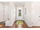 Inviting entryway with hardwood floors, a decorative rug, and views of the front yard through a glass door at 47 Coventry Ln, Chapel Hill, NC 27516