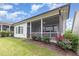 This exterior features a screened porch with lush flowering bushes in the yard at 47 Coventry Ln, Chapel Hill, NC 27516