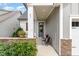 Charming front porch with stone accents, outdoor seating, and a view of the well-maintained front yard at 47 Coventry Ln, Chapel Hill, NC 27516