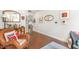 Hallway with hardwood floors, decorative art and a view into the adjacent living space at 47 Coventry Ln, Chapel Hill, NC 27516