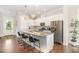 Contemporary kitchen island with granite countertops, white cabinetry, and stainless steel appliances at 47 Coventry Ln, Chapel Hill, NC 27516