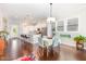 Bright open concept kitchen with white cabinets, stainless steel appliances and an adjacent dining area at 47 Coventry Ln, Chapel Hill, NC 27516