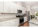 Contemporary kitchen with white cabinets, stainless steel appliances, and granite countertops at 47 Coventry Ln, Chapel Hill, NC 27516