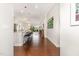 Open-concept living space with hardwood floors and a view of the kitchen, bar seating, and dining area at 47 Coventry Ln, Chapel Hill, NC 27516