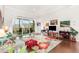 Bright living room with a floral rug, access to the balcony and an entertainment center at 47 Coventry Ln, Chapel Hill, NC 27516