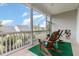 Inviting screened porch with rocking chairs overlooking the well maintained backyard at 47 Coventry Ln, Chapel Hill, NC 27516