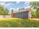 A full view of the backyard showing home exterior, wooden deck, and privacy fence at 500 Hunters Ridge Dr, Fuquay Varina, NC 27526