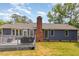 Backyard view of the deck, paver patio and the back of the home with brick chimney at 500 Hunters Ridge Dr, Fuquay Varina, NC 27526