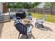 Paver patio with seating area, fire pit, and backyard access to the home's deck at 500 Hunters Ridge Dr, Fuquay Varina, NC 27526