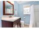 Light blue bathroom with a vanity, a toilet, and shower with curtain at 500 Hunters Ridge Dr, Fuquay Varina, NC 27526