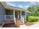 Close up of front porch with brick steps and columns and a wreath on front door at 500 Hunters Ridge Dr, Fuquay Varina, NC 27526
