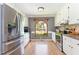 Charming kitchen with white cabinets, stainless steel appliances, and a view to the backyard at 500 Hunters Ridge Dr, Fuquay Varina, NC 27526