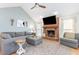 Bright living room with vaulted ceilings, fireplace and hearth, neutral paint, and stylish decor at 500 Hunters Ridge Dr, Fuquay Varina, NC 27526