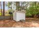 Backyard with white shed, wooden ramp, basketball hoop, and fence offers storage and recreational opportunities at 500 Hunters Ridge Dr, Fuquay Varina, NC 27526