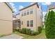 Rear view of the home with a screened porch, neutral siding and manicured lawn at 5003 Blue Jack Oak Dr, Cary, NC 27519