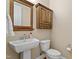 Charming half bath featuring a wooden mirror frame and wooden cabinet at 5003 Blue Jack Oak Dr, Cary, NC 27519