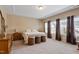 Comfortable bedroom featuring a queen-sized bed, matching nightstands, and large bright windows at 5003 Blue Jack Oak Dr, Cary, NC 27519