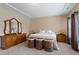 Comfortable bedroom featuring a queen-sized bed, matching nightstands, and a beautiful dresser with a decorative mirror at 5003 Blue Jack Oak Dr, Cary, NC 27519