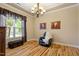 Cozy bedroom with hardwood floors, ample natural light, and comfortable seating at 5003 Blue Jack Oak Dr, Cary, NC 27519