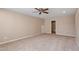 Expansive bedroom with neutral walls, carpet, ceiling fan, and access to a bathroom at 5003 Blue Jack Oak Dr, Cary, NC 27519