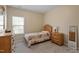 Cozy bedroom with neutral walls, carpet, window and wooden furniture at 5003 Blue Jack Oak Dr, Cary, NC 27519