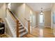 Elegant foyer and staircase featuring hardwood floors and a bright entryway at 5003 Blue Jack Oak Dr, Cary, NC 27519