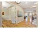 Bright foyer showcasing gleaming hardwood floors and views into other rooms at 5003 Blue Jack Oak Dr, Cary, NC 27519