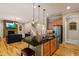 Modern kitchen with a large island, stainless steel appliances, and an open floor plan to the living room at 5003 Blue Jack Oak Dr, Cary, NC 27519