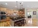 Open kitchen featuring a large island with seating, sleek appliances, and a view into the breakfast area at 5003 Blue Jack Oak Dr, Cary, NC 27519