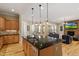 Bright kitchen with granite countertops, an island with pendant lighting, and stainless steel appliances at 5003 Blue Jack Oak Dr, Cary, NC 27519