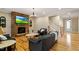 Comfortable living room with a stone fireplace, hardwood floors, and cozy seating at 5003 Blue Jack Oak Dr, Cary, NC 27519