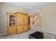Cozy living room with large built-in shelving and an ottoman with easy access to the staircase at 5003 Blue Jack Oak Dr, Cary, NC 27519