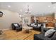 Open-concept living room and kitchen featuring hardwood floors and ample natural light at 5003 Blue Jack Oak Dr, Cary, NC 27519