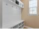 Mud room with built-in bench, storage cubbies, and coat hooks for organization near the entrance at 5003 Blue Jack Oak Dr, Cary, NC 27519
