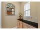 Pantry with ample storage cabinets and granite countertop with decorated mirror to complement the space at 5003 Blue Jack Oak Dr, Cary, NC 27519