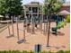 This playground in Amberly features a traditional colonial-style house in the background, and wood chip ground covering at 5003 Blue Jack Oak Dr, Cary, NC 27519