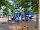 A brightly colored blue playground for residents is surrounded by trees at Amberly near the homes at 5003 Blue Jack Oak Dr, Cary, NC 27519