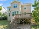Expansive backyard view of home showcasing a wooden deck and well-maintained lawn at 5011 Peachtree Town Ln, Knightdale, NC 27545