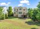 A spacious lawn area surrounding a home with a deck, ideal for outdoor activities at 5011 Peachtree Town Ln, Knightdale, NC 27545